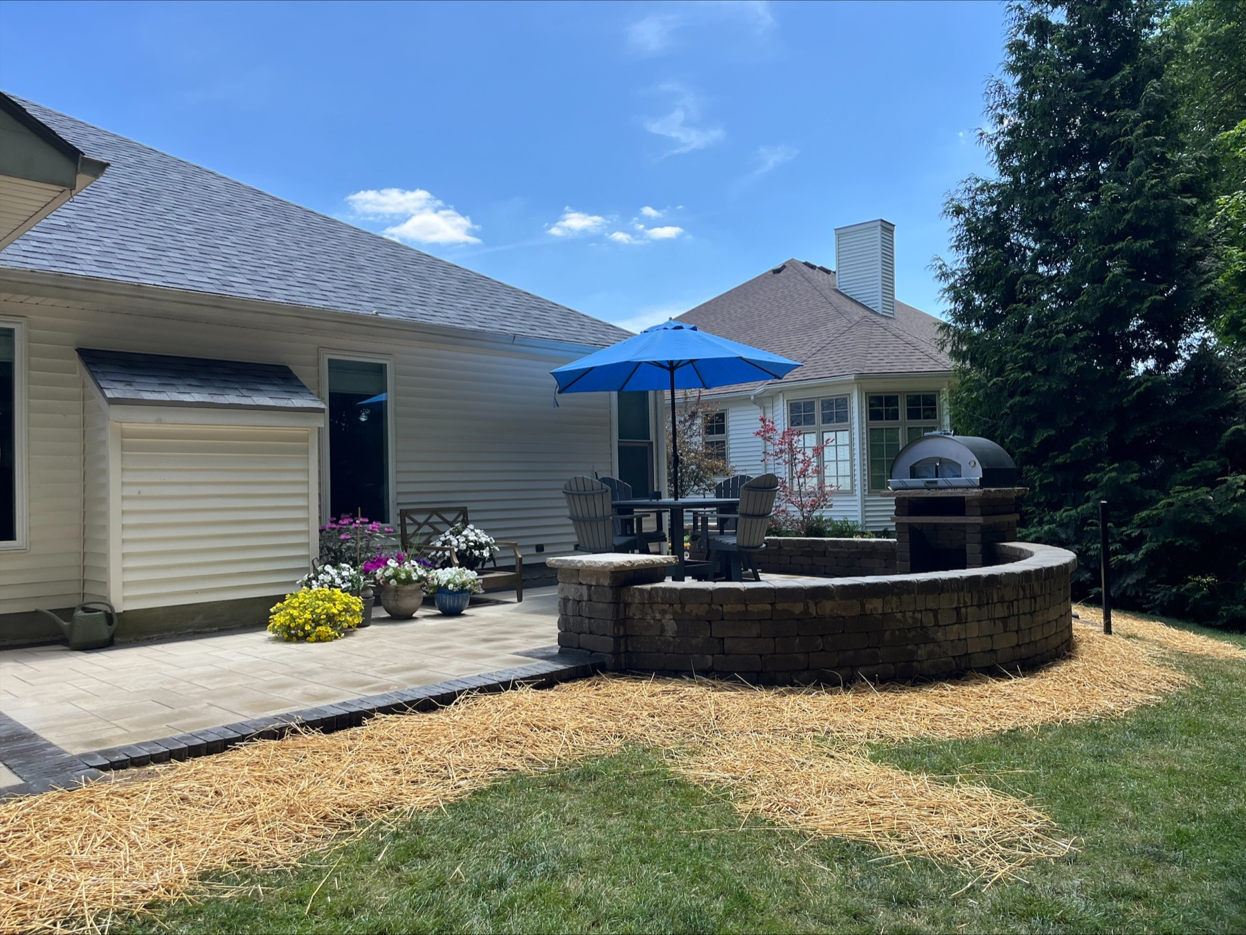 Finished backyard paver patio with an outdoor cooking area